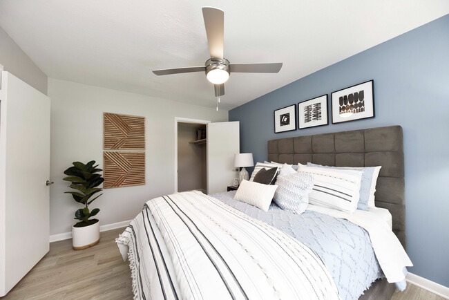 Bedroom with hardwood-style flooring and ceiling fan