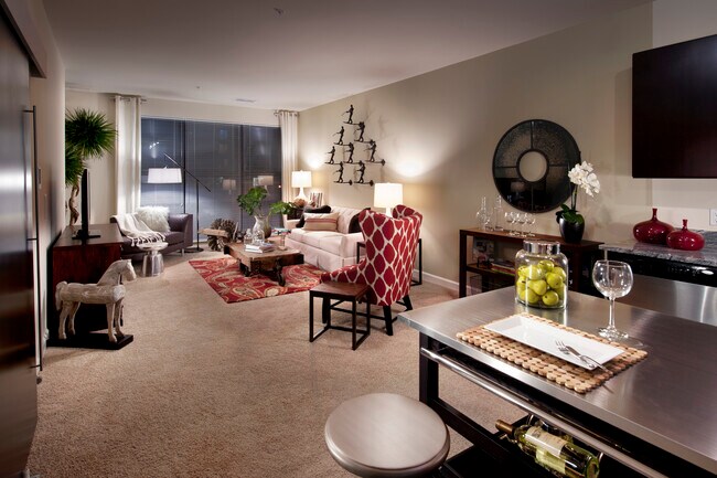 Open concept kitchen with movable island and living area with carpet