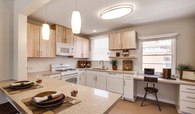 Kitchens have quartz countertops, gas stoves and breakfast bars in select homes