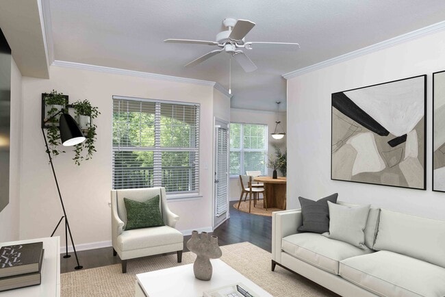 Living room with crown molding and ceiling fan