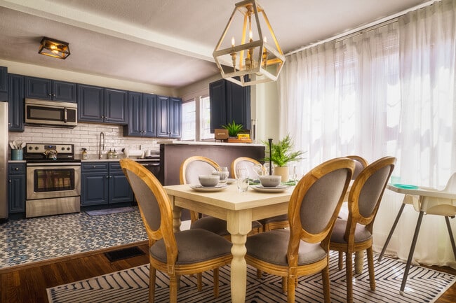 A cozy dining area bathed in natural light, featuring an elegant chandelier - 715 Grandin Rd