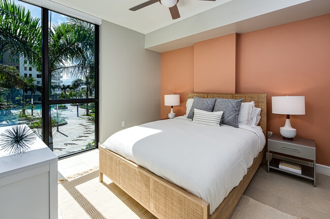 Spacious bedroom with hard surface flooring and ceiling fan
