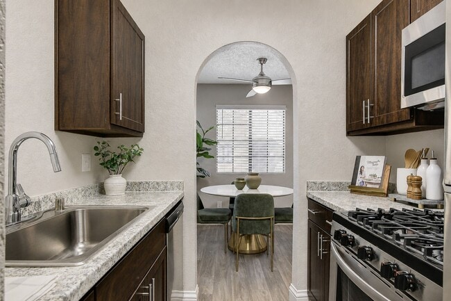 Step into Hidden Cove and admire the seamless blend of modern elegance and cozy charm. This inviting kitchen, with sleek finishes and spacious design, opens to a sunlit dining area perfect for gatherings. Elevate your lifestyle—schedule a tour today!