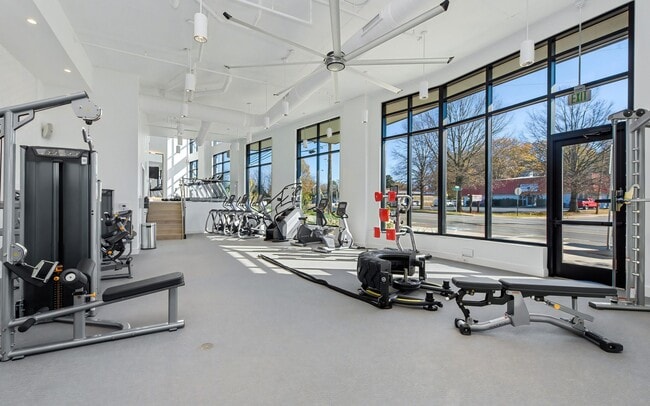Gym with Cable Weights, Treadmills, and Expansive Street-Facing Windows - NoDa Flats
