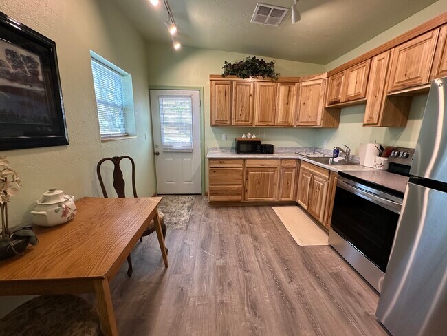Kitchen, front door opens into spacious new kitchen cabinets and appliances - 400 Main St Unit A