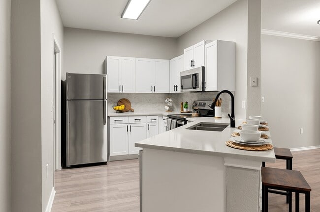 Kitchen with Stainless Steel Appliances and Quartz Countertops - Villas of Vista Ridge Apartments