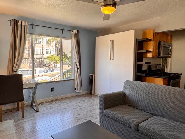 New couch cover (still a pull out sofa bed) - photo taken May 21 2025. More new photos soon! - 1045 1/2 Sanborn Ave