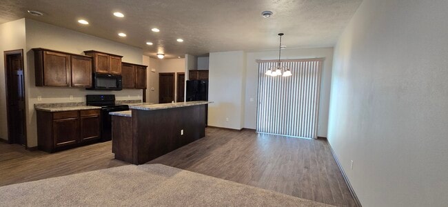 View of kitchen and dining area from living room. - 3511 E Bison Trl