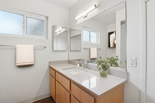Classic Package II bath with beige quartz countertop, oak cabinetry, and hard surface flooring