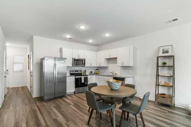 Open Kitchen with Stainless Steel Appliances and White Cabinetry