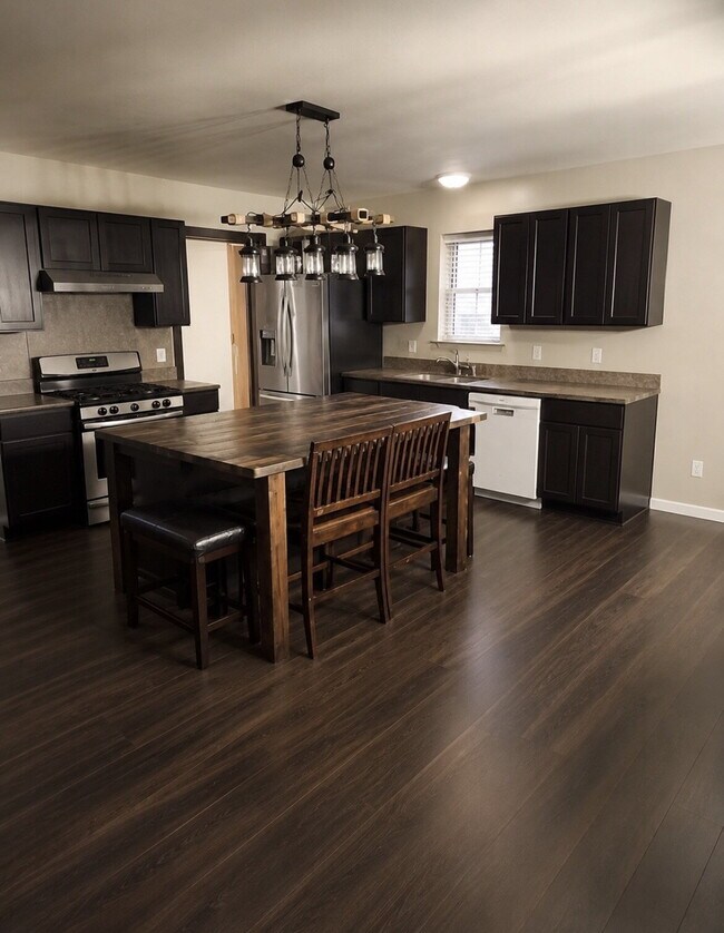 Spacious 5-Bed Retreat with Modern Updates in Aurora. Included - Greenhouse and Shed!