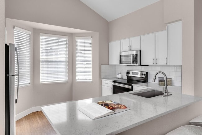 Kitchen with breakfast bar at The Links at Plum Creek in Castle Rock, CO - The Links at Plum Creek Apartments