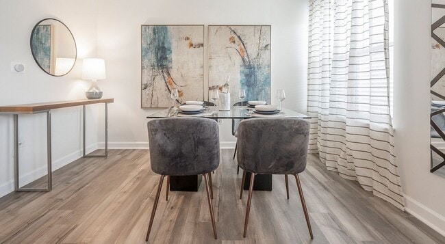 The dining area gets its own space, right beside a curtained window.