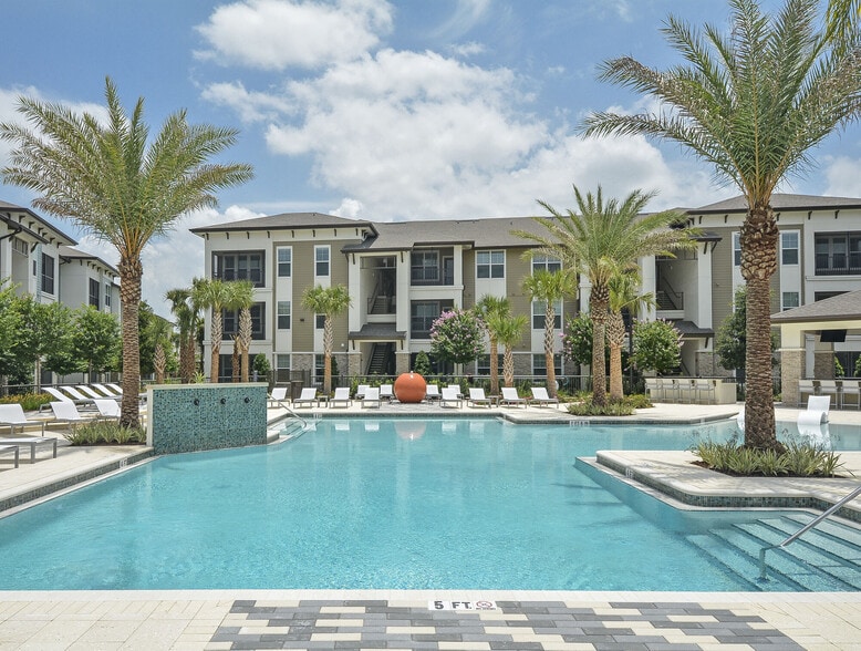 Beach Inspired Zero Entry Pool with Surrounding Sun Decks