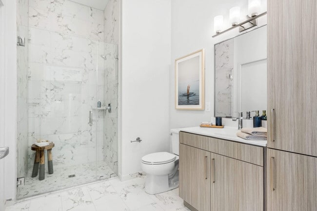 A step-in shower in the corner leaves the rest of the floor wide open.