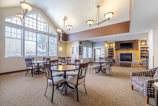 Elegant community lounge with large windows, stylish lighting, and modern decor for a welcoming atmosphere.