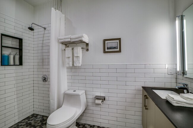 Tiled walls, built in storage shelf are a few of the subtle details of the finish outs.