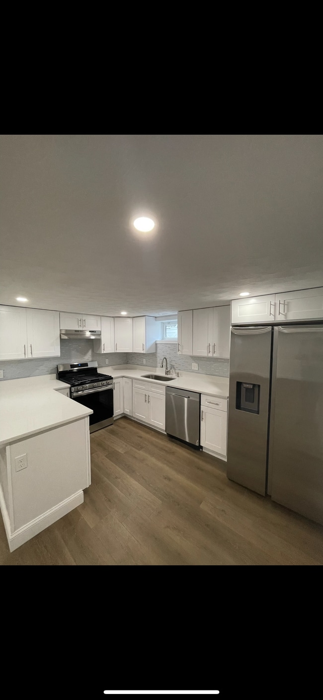 Kitchen is equipped with gas stove, dishwasher, and Samsung refrigerator - 31 Stowers St Apartments Unit 1
