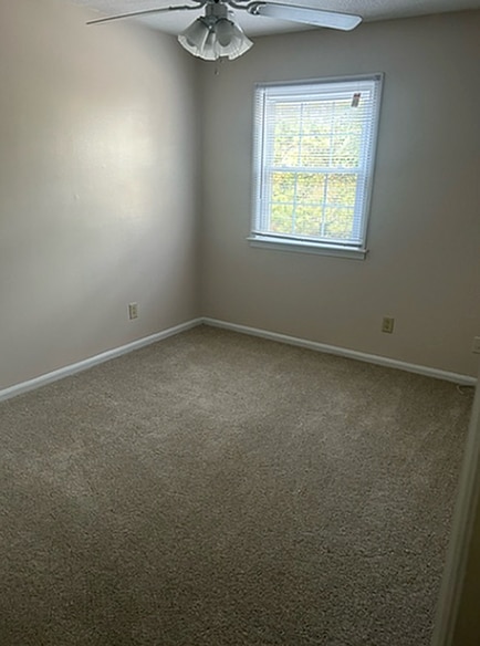 Experience comfort in this inviting bedroom, bathed in natural light from a generous window. - Corder Ridge