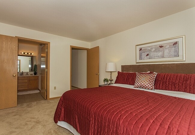 Primary Bedroom facing Ensuite Bathroom & Large Closet