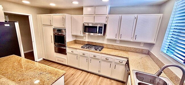 kitchen with brand-new microwave, gas stove, refrigerator and DISHWASHER! - Montana Apartments