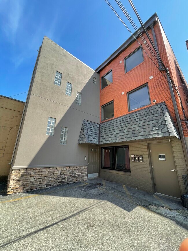Back of Building (gray building on the left is the main entrance) - 307 Freeport Rd Apartments Unit 2