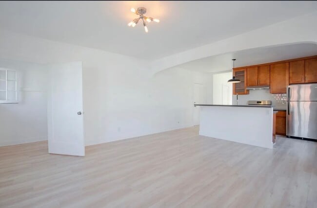 view from the living room looking at kitchen. View of front door plus a closet where door is open - 1704 Miramar St Unit 1706