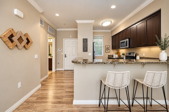 Step inside The Pointe, where modern design meets comfort. This inviting kitchen features sleek granite countertops and ample natural light, perfect for culinary enthusiasts. View your future home today and elevate your lifestyle!