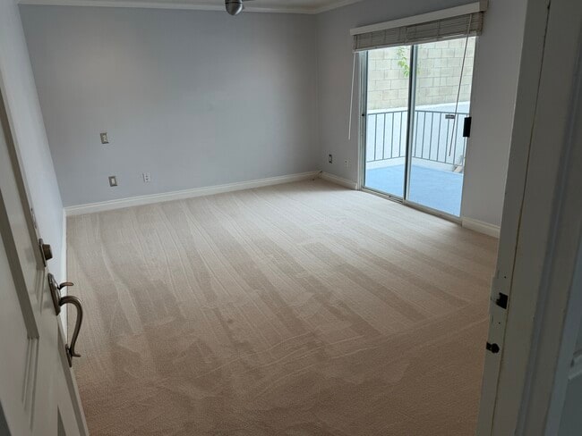 Entry into living room and view of balcony 1 - 1649 Appian Way Unit 210