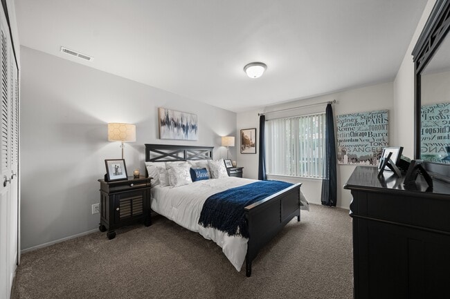 Spacious bedroom with ample storage space at Knottingham Apartments in Clinton Township, MI. - Knottingham Apartments
