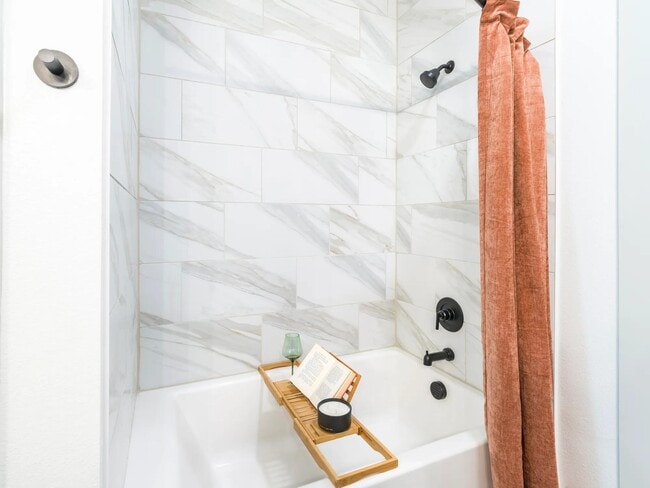 Designer bathrooms with quartz countertops and soaking tubs.