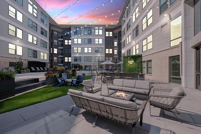 Poolside firepit area includes TV and grilling area