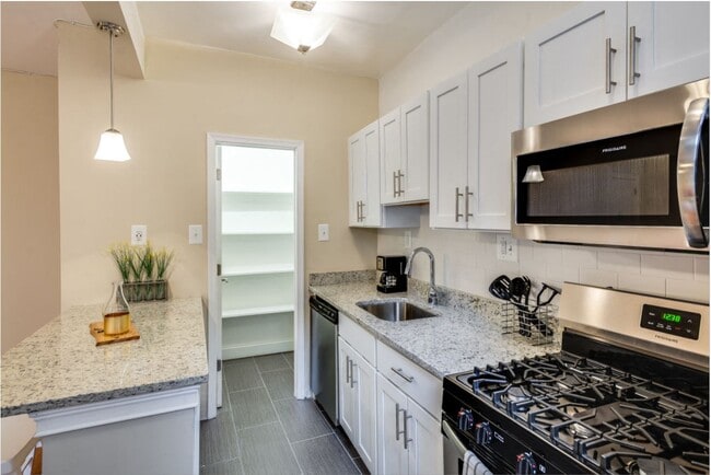 Renovated kitchen with stainless steel appliances and granite countertops