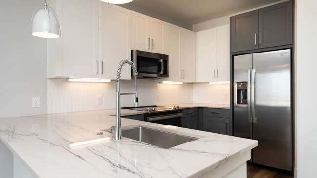 Kitchen with Marble Countertops and Stainless Steel Appliances