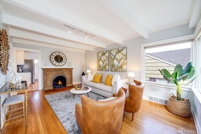 Formal Living room with fireplace and box beam ceiling. - 4749 37th Ave SW