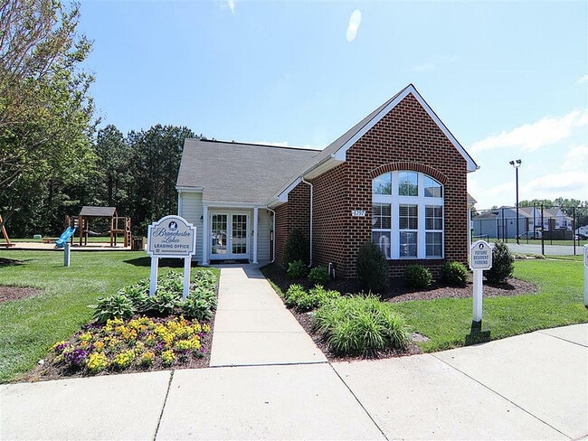 Welcome to our charming leasing office, surrounded by lush greenery and bright blooms. - Branchester Lakes Apartments