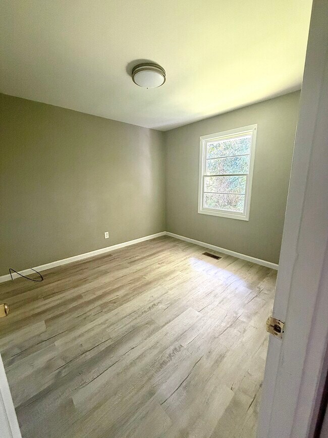 Bedroom 2 - natural light, updated flooring, and a neutral color palette. - 112 Live Oak Dr Unit 110