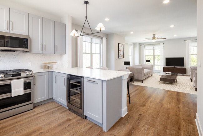 Signature Collection kitchen and living room with hard surface flooring