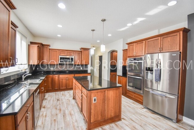 Photo - 4 Bedroom 4 Bath Executive Home in West Des Moines with a fenced in yard and a 3-car garage