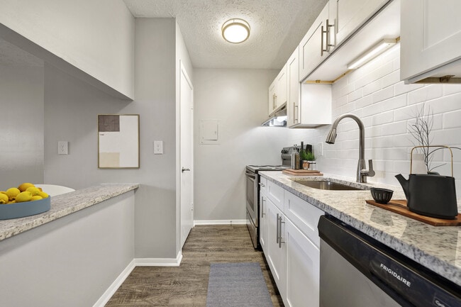 Modern kitchen with stainless steel appliances and granite countertops at Rio at Lenox.
