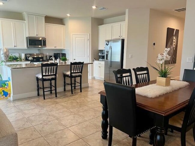 Photo - Open concept home offering four bedrooms, three baths, a two car garage and open lanai.