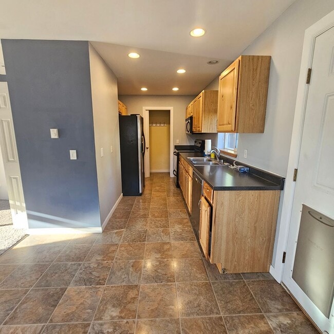 Photo - Charming 1-Bedroom Home with Spacious Backyard, 2 car garage & Modern Amenities – Pet Friendly!
