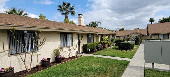 Beautiful ambiance along walkways at Las Casitas Apartments in Riverside, California. - Las Casitas Apartments