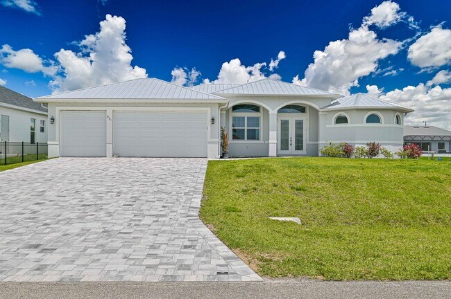Building Photo - NOW AVAILABLE - Gorgeous Pool Home ~ NW Cape ~ 3 Car Garage ~ On Canal!
