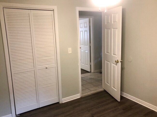 2nd bedroom with new flooring, paint and ceiling fan - 9801 N Aster Ave Townhome