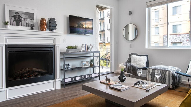 Apartment living room with wood-style flooring, fireplace and balcony.