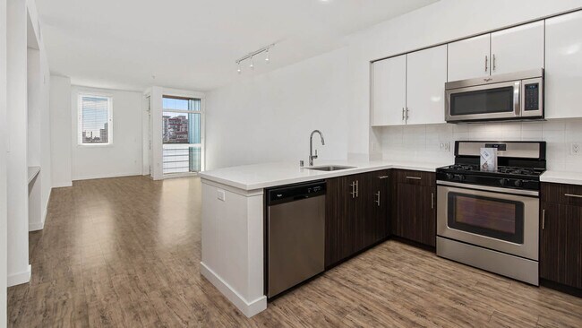 Kitchen with Quartz Countertops and Stainless Steel Appliances - Parc on Powell