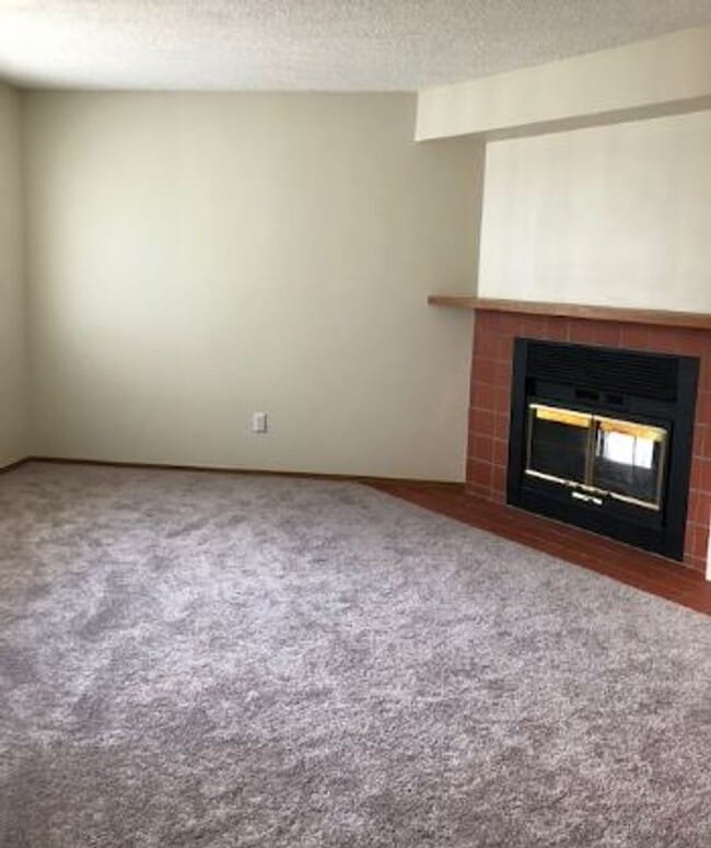 Photo - 2 BR/1BA | Newly Renovated Unit | Front Patio| Fireplace in living room!