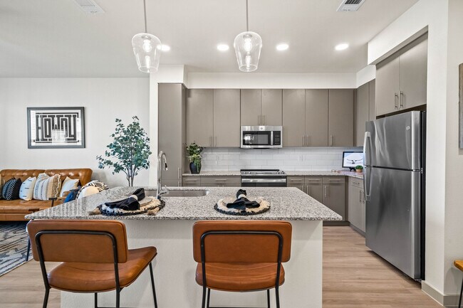 Stainless Steel Appliances and Gray Cabinets