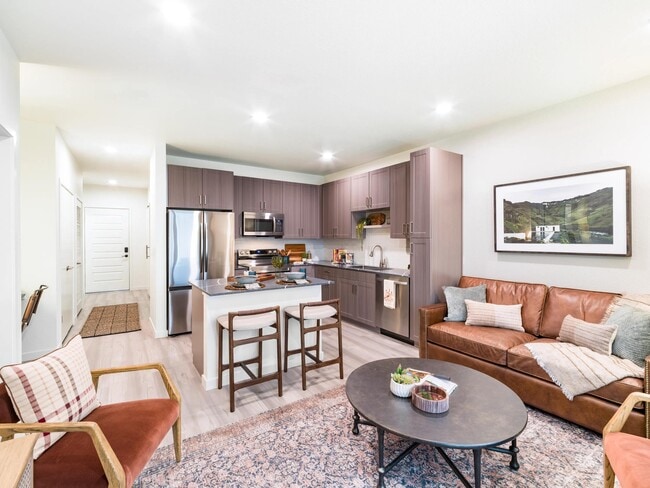 An open-concept apartment home at Modera University Park, where kitchen, dining, and living spaces come together for effortless everyday living.
